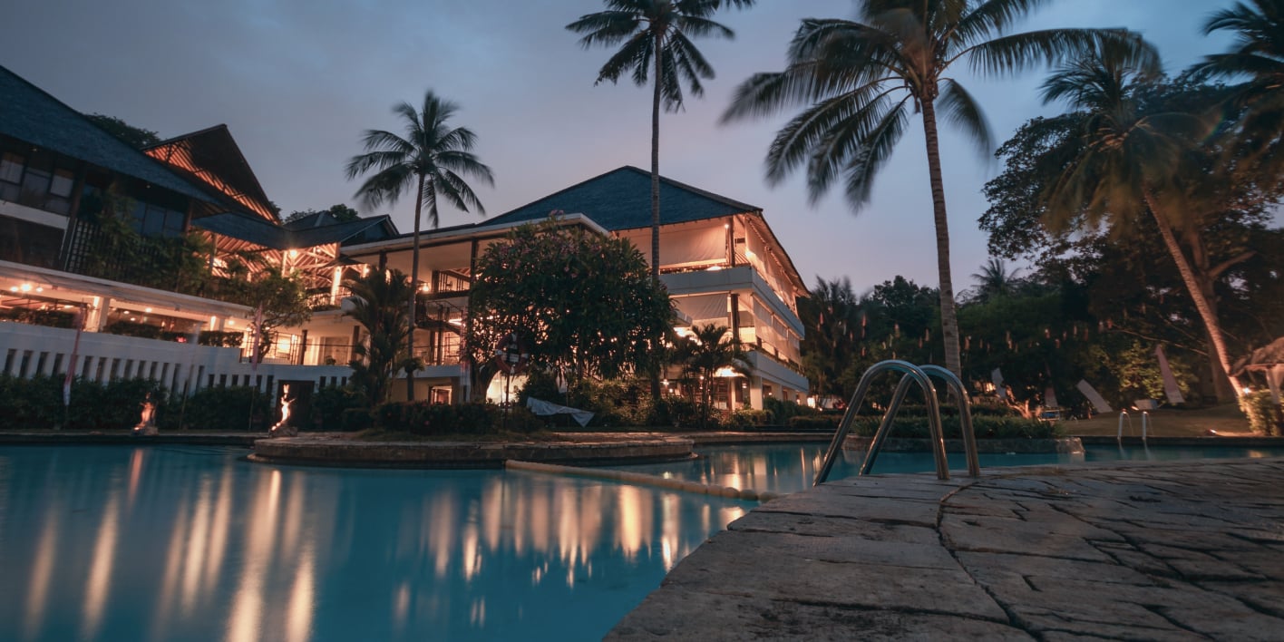 A view of a hotel from the pool